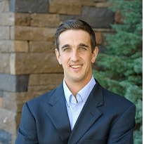 Image of Luke Ross in a suit smiling